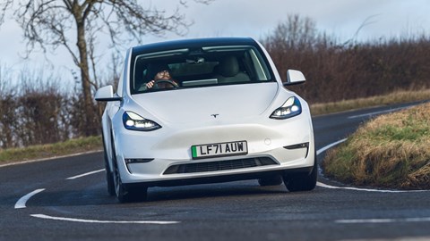 Best electric SUVs - Tesla Model Y, white, front view, driving round corner